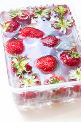 Strawberries in a bowl of water. Red berries. Seasonal berries in the water.
