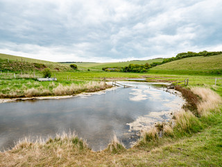 Fototapeta na wymiar River Cuckmere, Sussex, England. The flood plains of Cuckmere Haven at the Seven Sisters park in the English South Downs nature reserve.