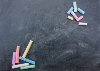 Dark board with colored pencils for drawing. space for copying. draw chalk on a blackboard....
