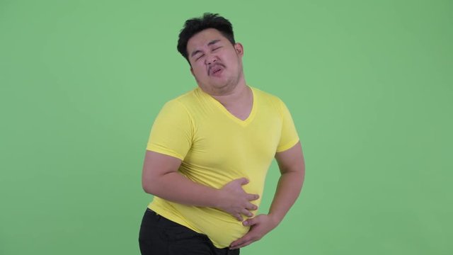 Funny young overweight Asian man farting