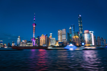 Shanghai, China - JUN 21 , 2018 :Nightscape of Lujiazui skyline as seen from the Bund, across the Huangpu. Zoom to across the night view. Night panorama of beautiful Shanghai city with bright lights,