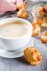 French coconut cookies congolais with coffee mug, grey stone or concrete background copy space