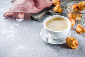 French coconut cookies congolais with coffee mug, grey stone or concrete background copy space