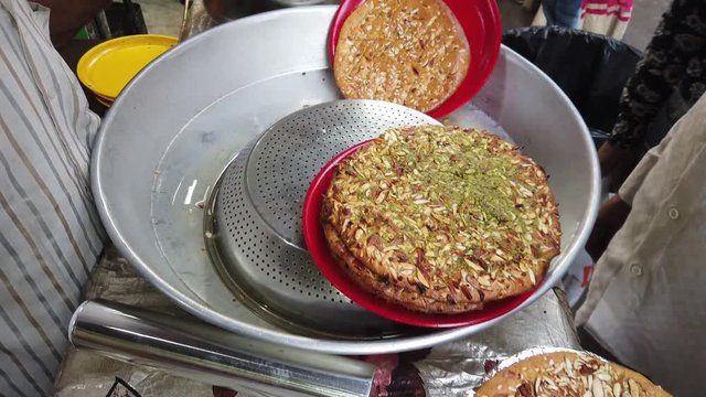 Street food- Sheermal or Shirmal, a saffron-flavored traditional flat-bread with almonds originally from greater Iran , popular in India, Pakistan and Bangladesh. 4k 60fps close-up stabilized handheld