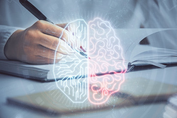 Double exposure of woman's writing hand on background with brain hologram. Concept of brainstorming.