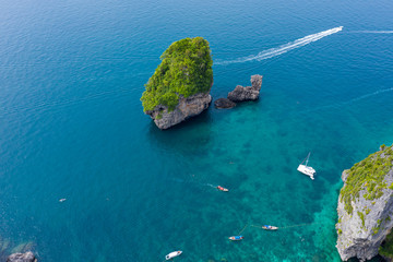long tail and speed boat chartered for snorkelling at phi phi island in the tourist high season of...