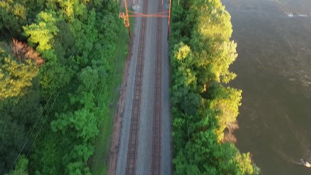 Aerial shot with tilt up of the train tracks near the Susquehanna river and the Chickies Rock Overlook.