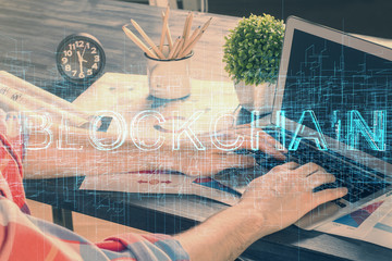 Crypto currency theme hologram with businessman working on computer on background. Concept of...