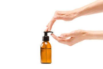 cropped view of woman pumping body lotion from dispenser bottle isolated on white