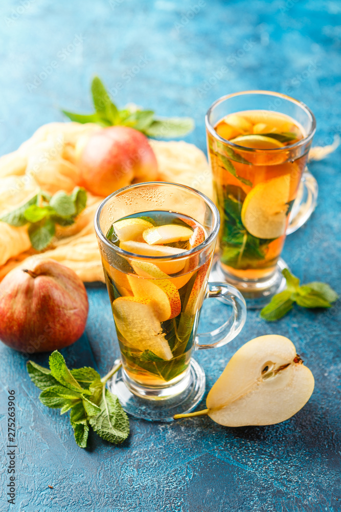 Wall mural Hot fruit tea with ripe pears and mint