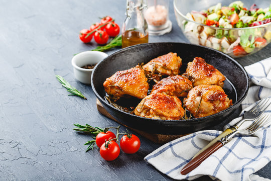 Delicious fried chicken thighs in a cast iron skillet
