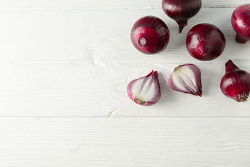 Flat lay composition with red onion on white wooden background