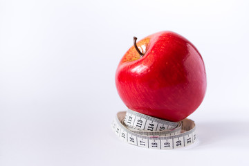 red apple with measuring tape isolated on white