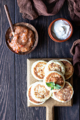 Cottage cheese pancakes or fritters with jam and mint. Traditional Ukrainian and Russian cuisine. Syrniki. Healthy and diet breakfast.