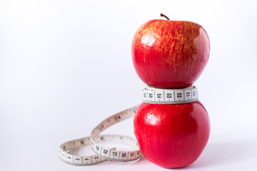 red apple with measuring tape isolated on white