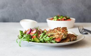 Chicken or turkey cutlets with vegetables and sauce on a plate. Delicious cutlets with salad. Selective focus.