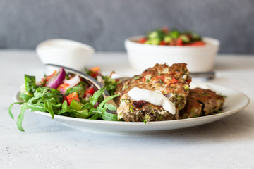Chicken or turkey cutlets with vegetables and sauce on a plate. Delicious cutlets with salad. Selective focus.