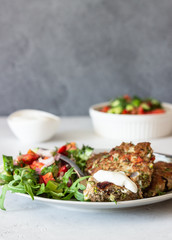 Chicken or turkey cutlets with vegetables and sauce on a plate. Delicious cutlets with salad. Selective focus.