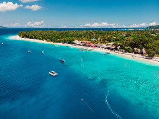 Tropical beach and turquoise ocean with boats. Aerial view. Paradise holiday resort