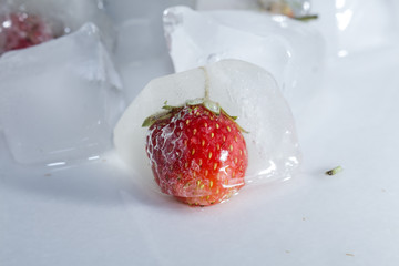 Frozen strawberries and square ice cubes