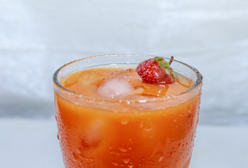 Сarrot juice with strawberries and ice