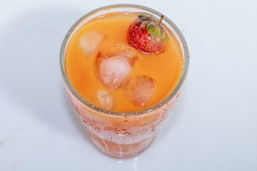 Сarrot juice with strawberries and ice
