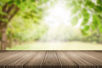 Naklejka na ściany i meble Empty wooden table with garden bokeh for a catering or food background with a country outdoor theme,Template mock up for display of product
