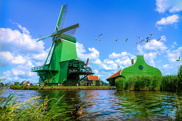 The famous Zaanse Schans mills in Zaandam, on the Zaan river. Famous holland attraction, windmills. - obrazy, fototapety, plakaty