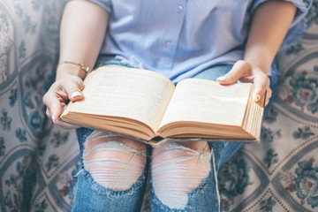 A beautiful girl, reading a book, concepts of home and comfort, place for text