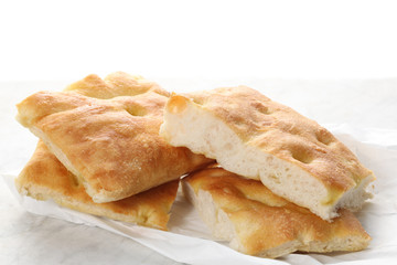 slices of traditional italian focaccia  rest on a marble table with copy space for your text