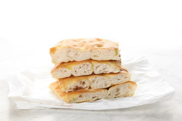 slices of traditional italian focaccia  rest on a marble table with copy space for your text