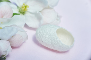 Fototapeta na wymiar silkworm cocoon close-up for beauty treatments and flowers.