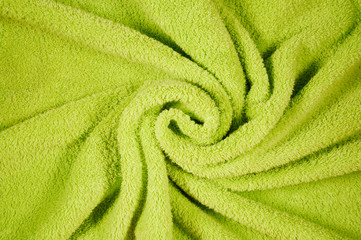 Fototapeta na wymiar draped Towel texture close up for a decor by decorative spiral folds. background and copy space