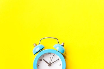 Ringing twin bell vintage classic alarm clock Isolated on yellow colourful trendy modern...