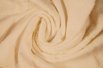 draped Towel texture close up for a decor by decorative spiral folds. background and copy space