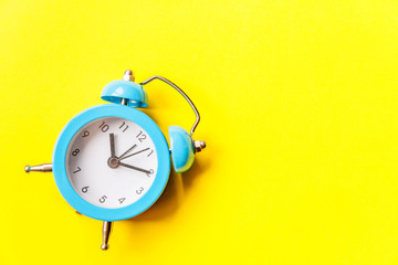 Ringing twin bell vintage classic alarm clock Isolated on yellow colourful trendy modern background. Rest hours time of life good morning night wake up awake concept. Flat lay top view copy space