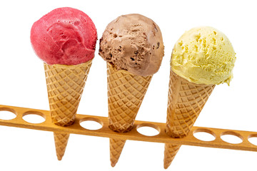 Chocolate, vanilla and strawberry Ice cream in the cone in test tubes support on white background