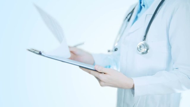 Doctor woman reading patient's information, health and medical concept.