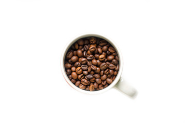 coffee beans brown closeup with blurred background in Cup on white isolated background