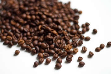 Fototapeta na wymiar coffee beans brown on white isolated background with close-up location with blurred background