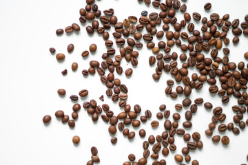 brown coffee grains on a white isolated background with space top view