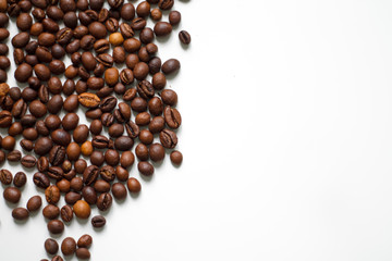 brown coffee grains on a white isolated background with space top view