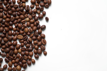 brown coffee grains on a white isolated background with space top view