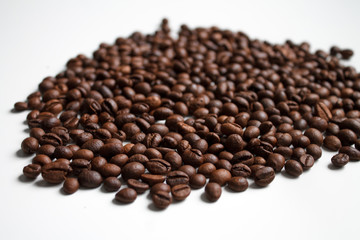 coffee beans brown on white isolated background with close-up location with blurred background