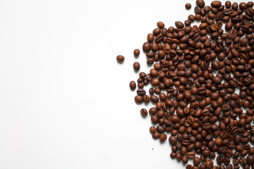 brown coffee grains on a white isolated background with space top view