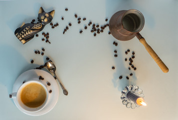 the cup of coffee, candle and cat  on the white background