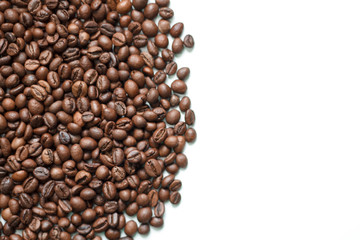 brown coffee grains on a white isolated background with space top view