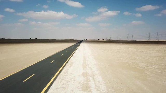 Dubai empty desert road drone with cycling girl