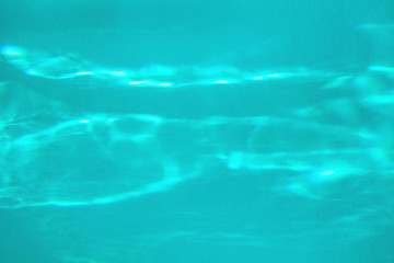 Trendy blue colored abstract background with light and shadows caustic effect. Light passes through a glass.