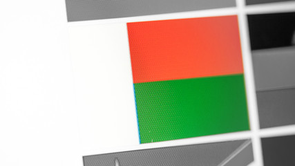 Madagascar national flag of country. Madagascar flag on the display, a digital moire effect.